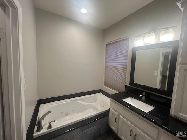 bathroom with a whirlpool tub and vanity