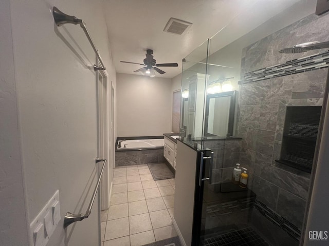 bathroom with ceiling fan, a garden tub, visible vents, tiled shower, and tile patterned floors