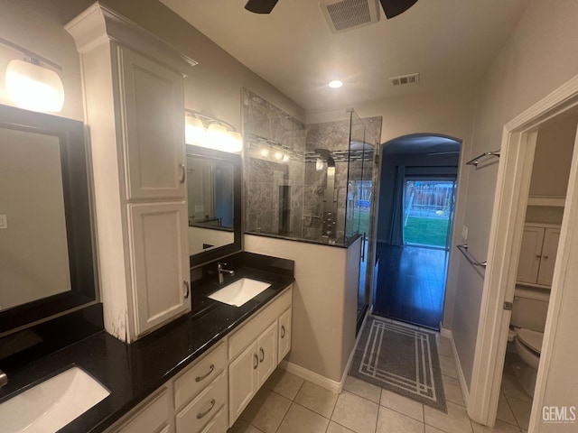 full bathroom featuring double vanity, a sink, visible vents, and a shower stall