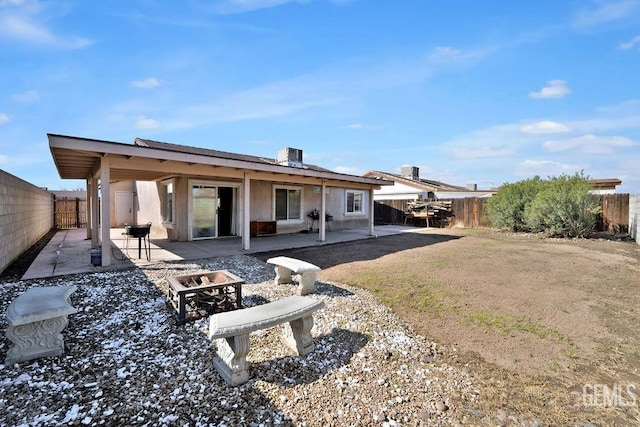 back of property featuring an outdoor fire pit, a patio area, a fenced backyard, and central air condition unit