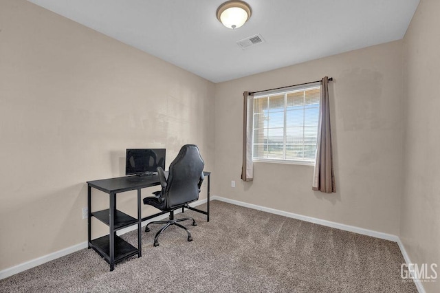 carpeted office space featuring visible vents and baseboards