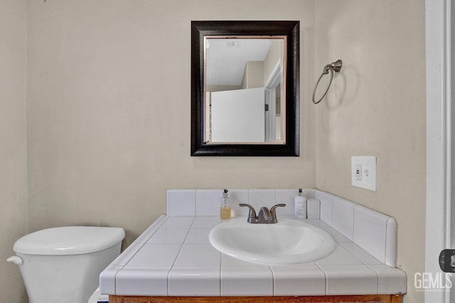 bathroom with vanity and toilet