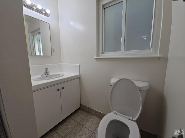 bathroom featuring tile patterned flooring, vanity, and toilet