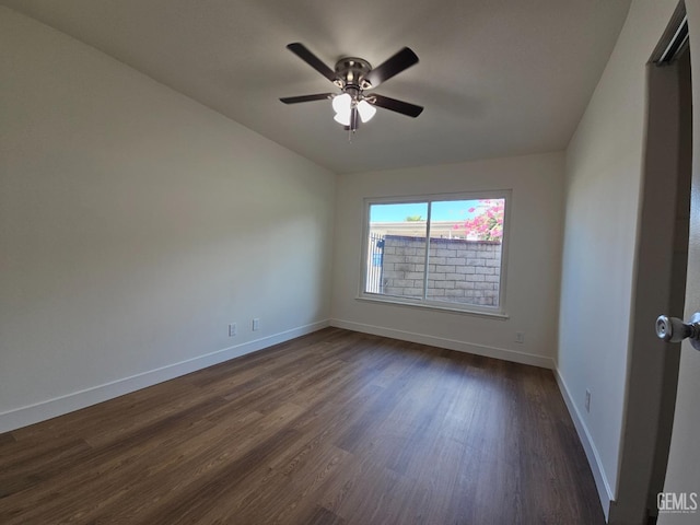 unfurnished room with dark hardwood / wood-style floors and ceiling fan