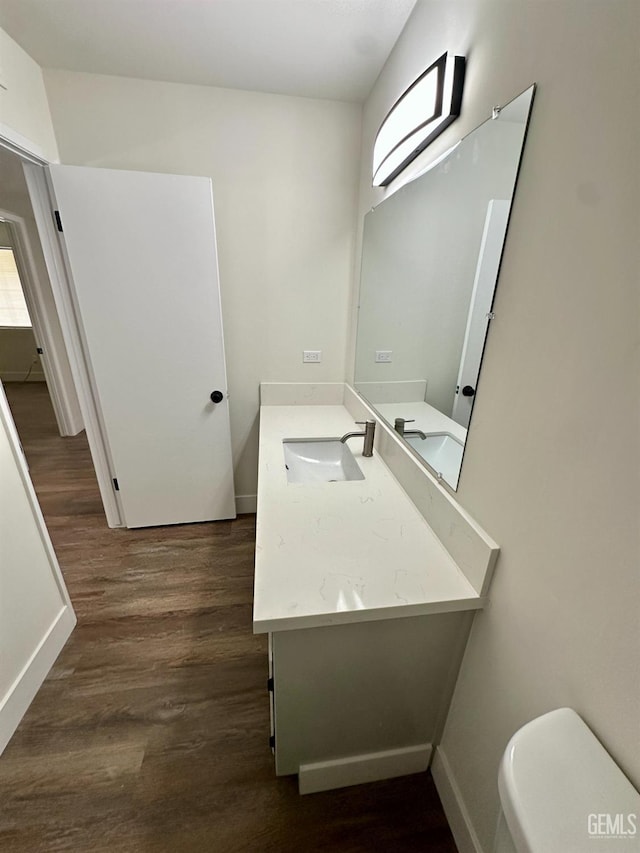 bathroom with vanity, wood-type flooring, and toilet