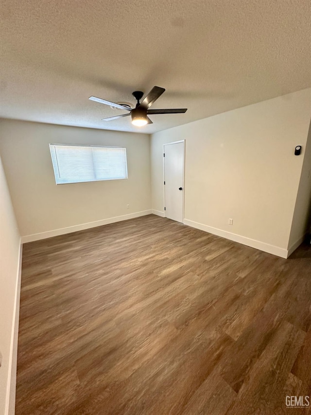 spare room featuring a textured ceiling, dark hardwood / wood-style floors, and ceiling fan