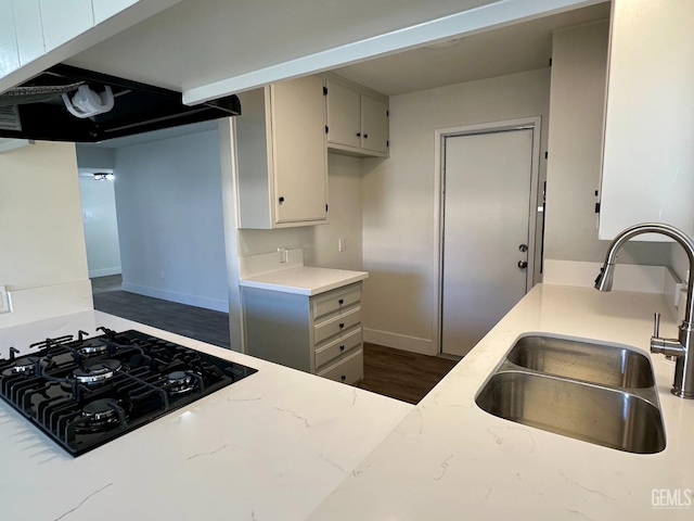 kitchen with dark hardwood / wood-style floors, black gas cooktop, and sink