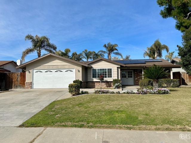 ranch-style house with a garage, a front lawn, and solar panels