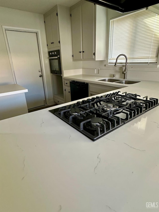 kitchen featuring white cabinetry, sink, and black appliances