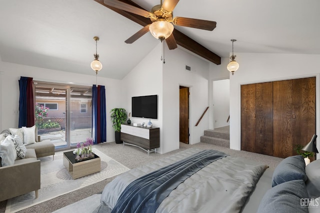 bedroom featuring lofted ceiling with beams, light carpet, and a closet