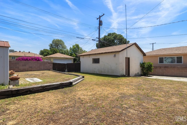 view of yard with a fenced backyard and an outdoor structure
