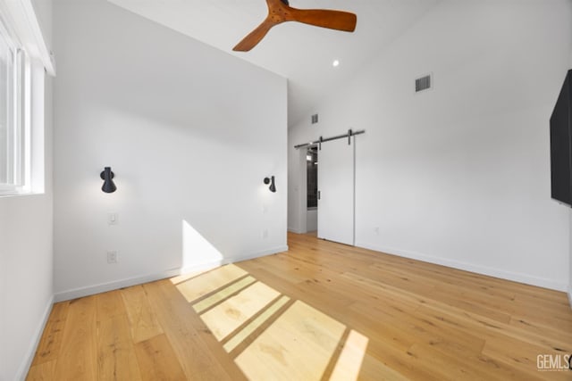 662 Woodland Ct, Arroyo Grande, CA 93420 - spare room featuring a ceiling fan, light wood finished floors, a barn door, and high vaulted ceiling