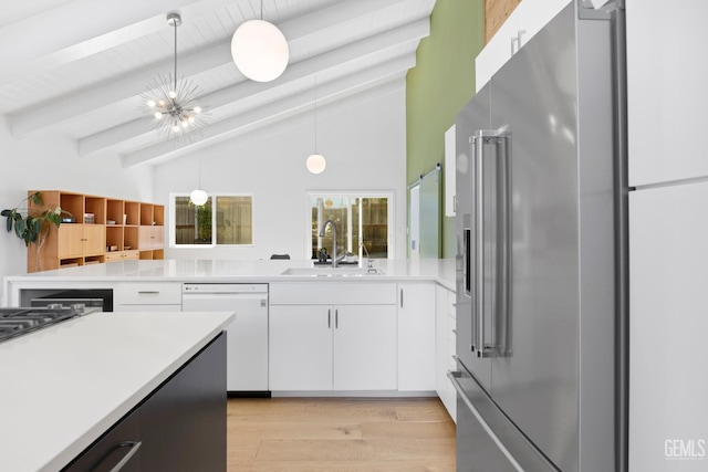 662 Woodland Ct, Arroyo Grande, CA 93420 - kitchen with stainless steel appliances, light countertops, light wood finished floors, white cabinets, and hanging light fixtures