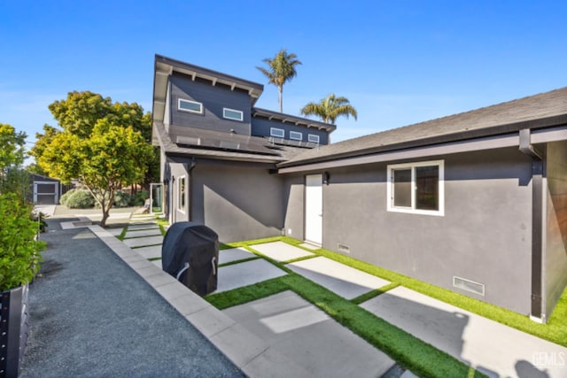 662 Woodland Ct, Arroyo Grande, CA 93420 - back of house featuring stucco siding, crawl space, a patio area, and roof mounted solar panels