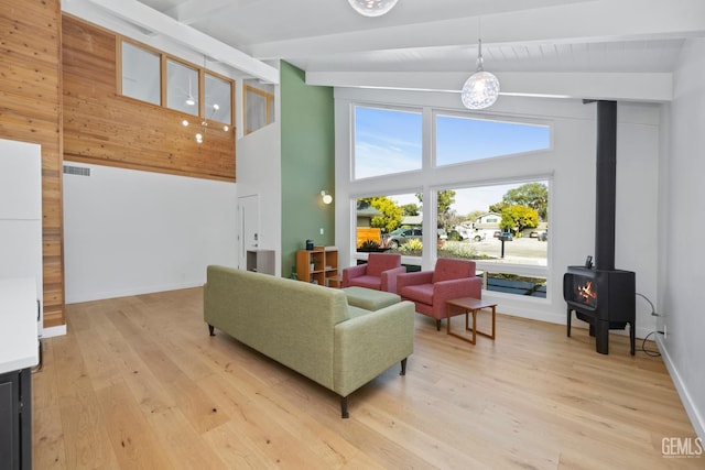 662 Woodland Ct, Arroyo Grande, CA 93420 - living room featuring beam ceiling, a wood stove, high vaulted ceiling, and light wood-style floors
