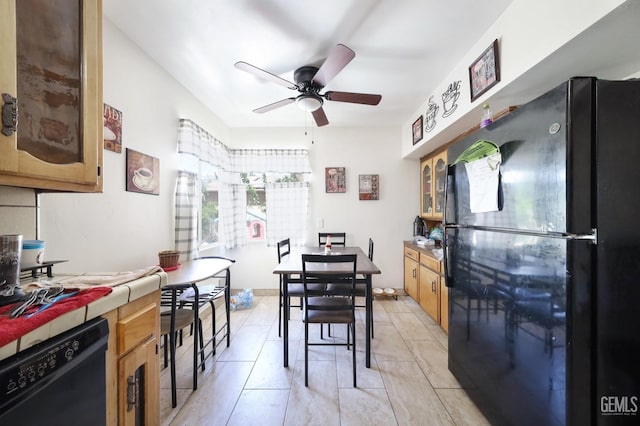 dining space with ceiling fan and light tile patterned floors