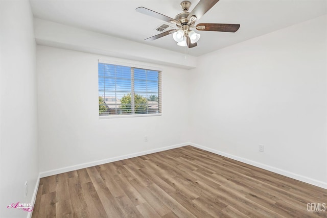 empty room with wood finished floors and a ceiling fan