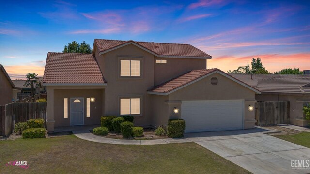 view of front of house featuring a tiled roof, stucco siding, concrete driveway, and a garage