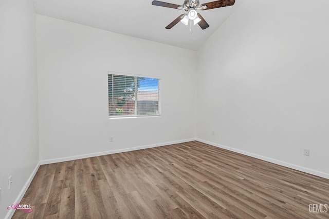 spare room with wood finished floors, ceiling fan, and vaulted ceiling