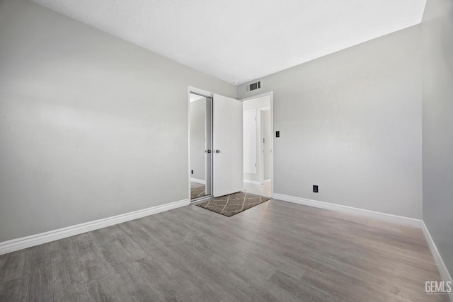 empty room featuring hardwood / wood-style flooring