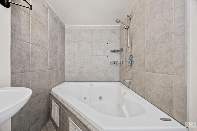 bathroom with sink and tile walls