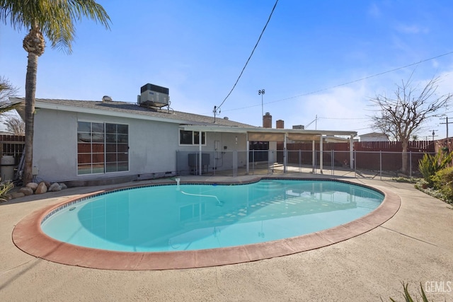 view of pool with cooling unit and a patio