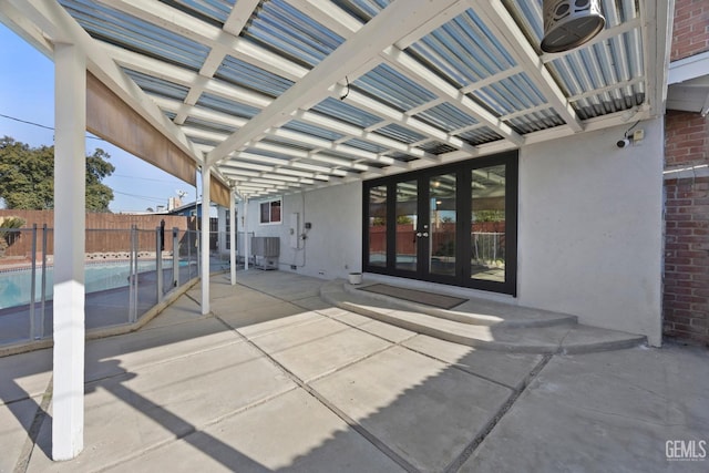 view of patio / terrace featuring central air condition unit, french doors, and a pergola