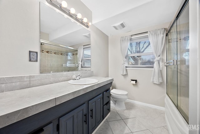 full bathroom with vanity, toilet, enclosed tub / shower combo, and tile patterned flooring