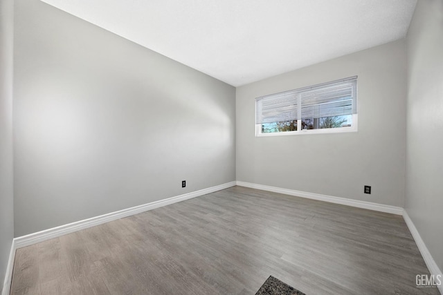 spare room with wood-type flooring