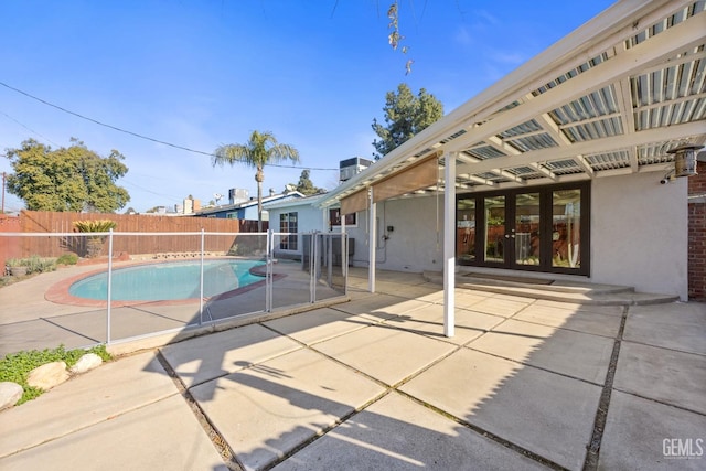 view of pool featuring french doors and a patio area