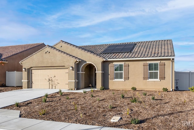 4920 Tachi Ave, Bakersfield, CA 93306 - mediterranean / spanish home with a garage, concrete driveway, solar panels, stucco siding, and a tile roof