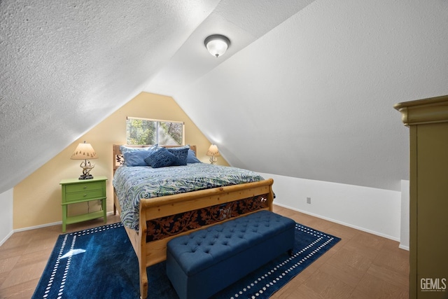 bedroom with a textured ceiling, baseboards, and vaulted ceiling