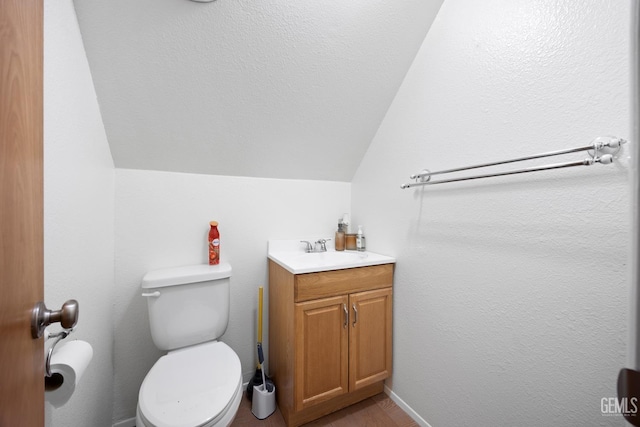 half bathroom featuring toilet, vanity, and lofted ceiling