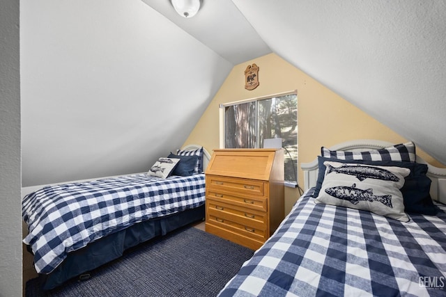 carpeted bedroom with lofted ceiling