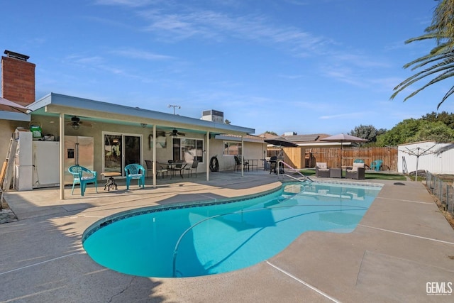 view of pool with central AC, ceiling fan, and a patio