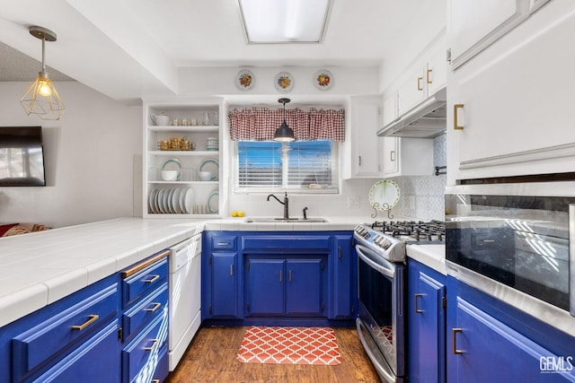 kitchen featuring dishwasher, stainless steel gas stove, sink, pendant lighting, and white cabinets