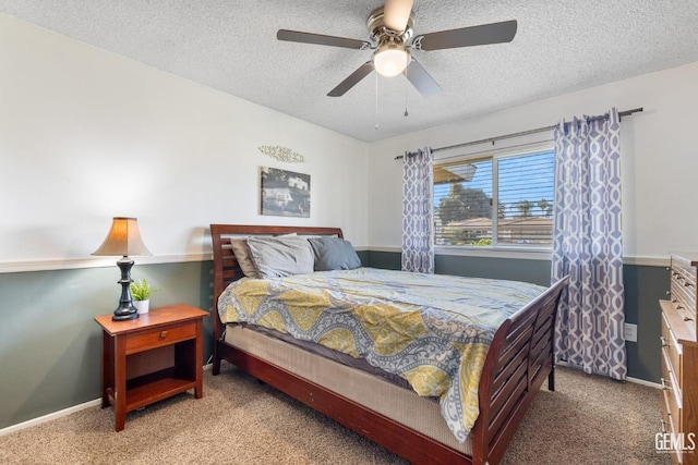 carpeted bedroom with a textured ceiling and ceiling fan