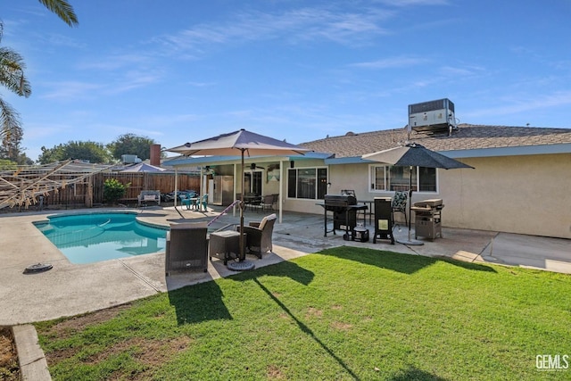 view of swimming pool with a patio, grilling area, a lawn, and central air condition unit