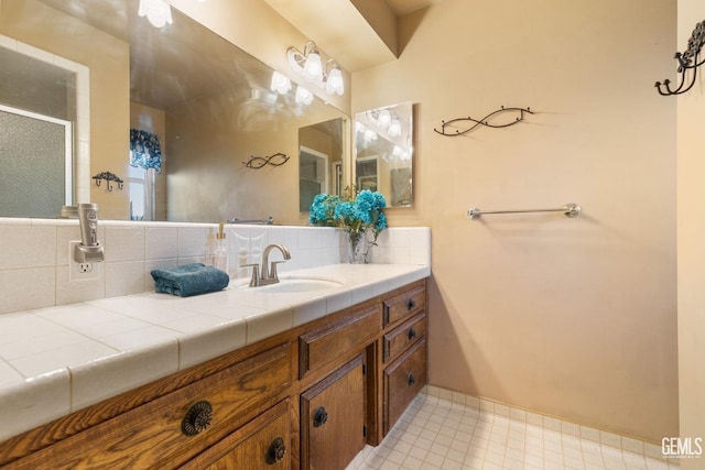 bathroom featuring vanity and backsplash