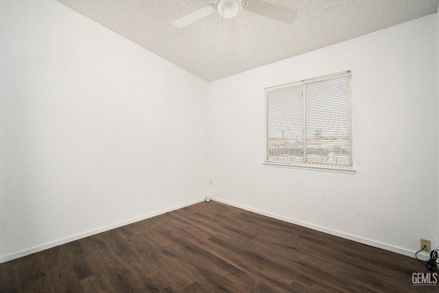 unfurnished room with a textured ceiling, ceiling fan, vaulted ceiling, and dark hardwood / wood-style floors