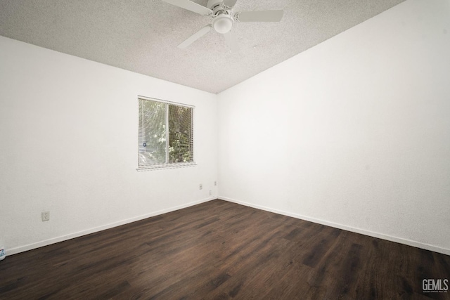 empty room with a textured ceiling, ceiling fan, lofted ceiling, and dark hardwood / wood-style floors