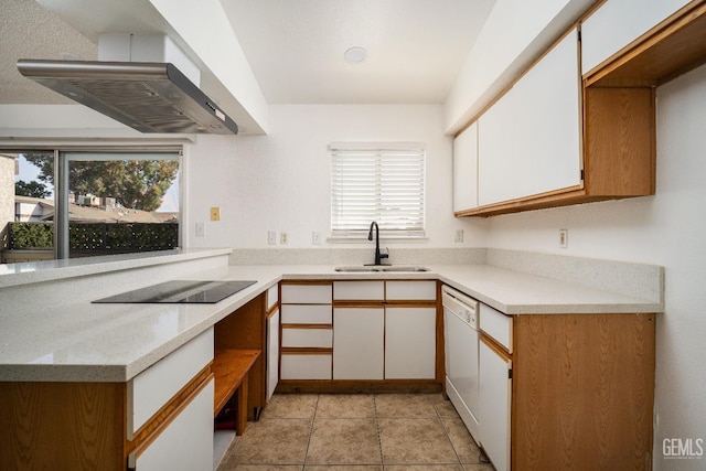 kitchen with sink, white cabinets, wall chimney range hood, and black electric cooktop