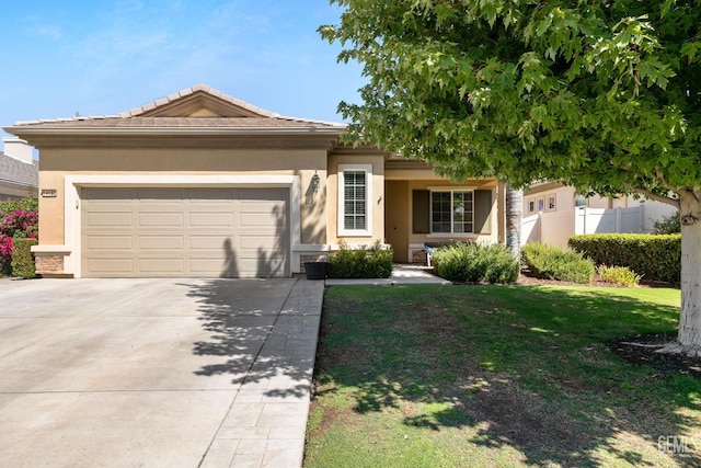 view of front of property featuring a garage and a front lawn