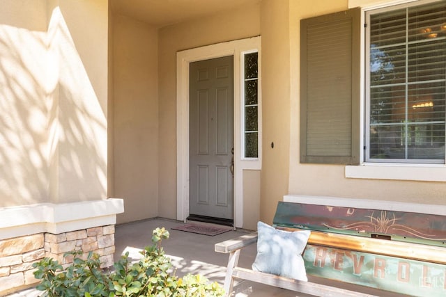 view of exterior entry featuring a porch