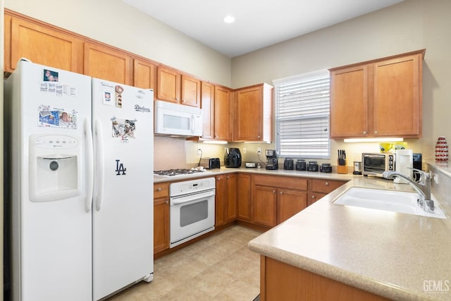 kitchen featuring sink and white appliances