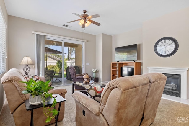 carpeted living room featuring ceiling fan