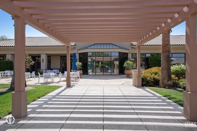 view of home's community with a pergola and a patio