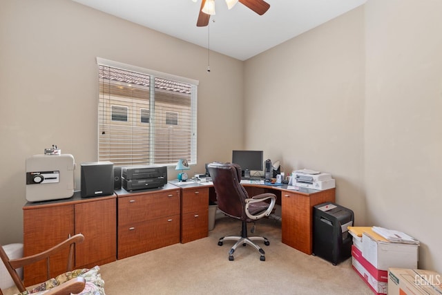 office space with ceiling fan and light carpet