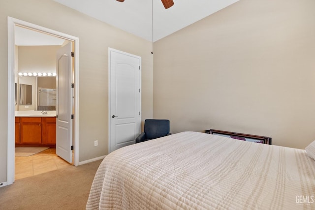 carpeted bedroom with ensuite bath, ceiling fan, and sink