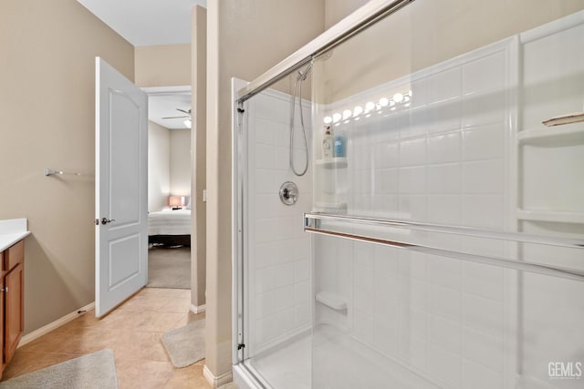 bathroom featuring tile patterned flooring, vanity, and a shower with shower door